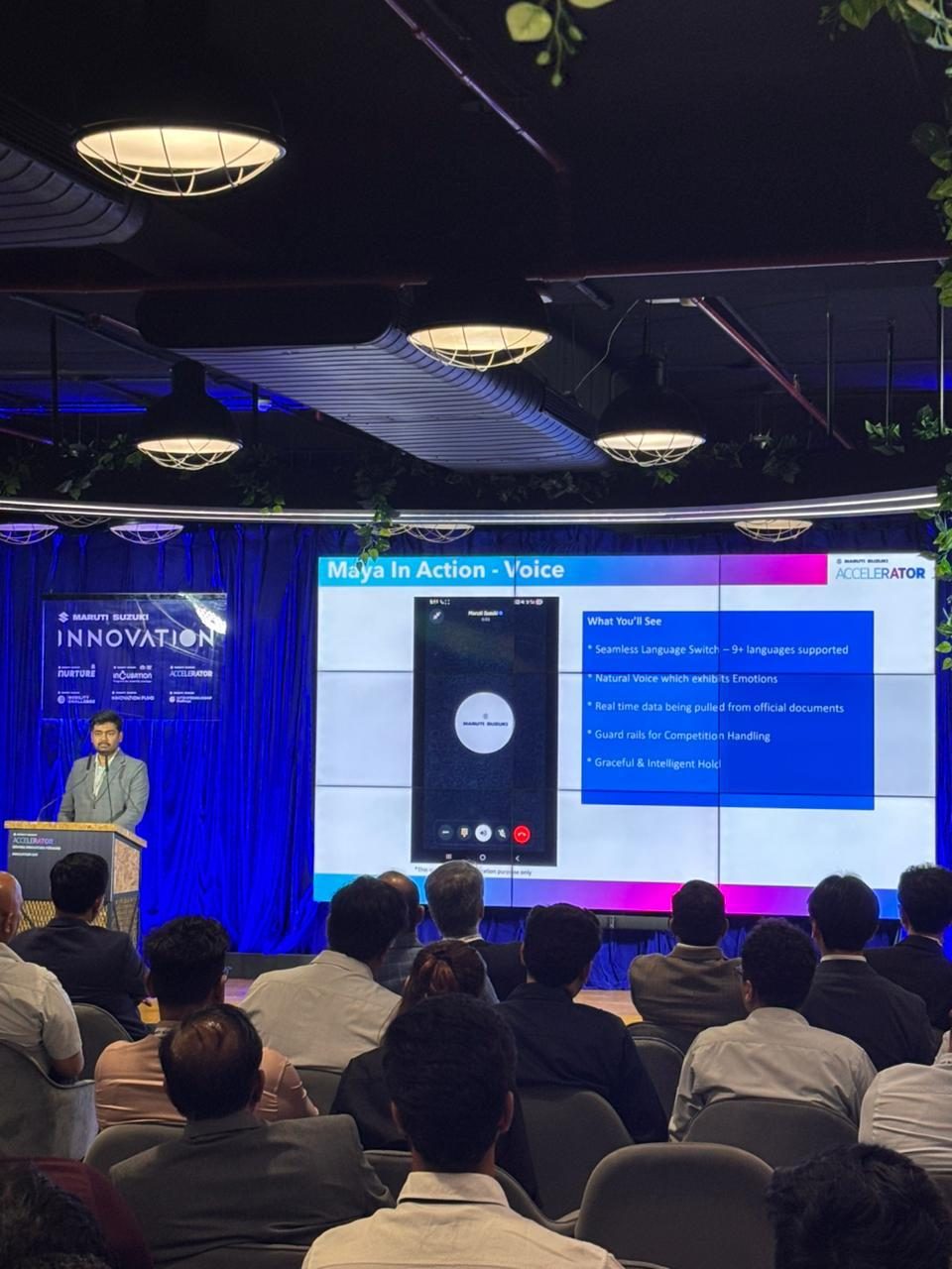 Keerthi at the podium during the Maya voice demo at the Maruti Suzuki Accelerator